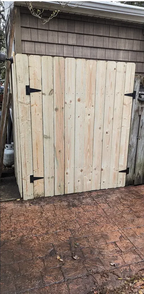 A new wooden gate built and hung by our handyman