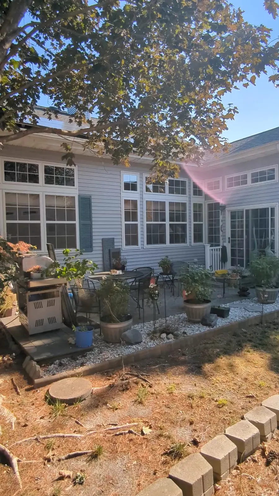 Washing the back windows of a home in Barnegat, NJ, from a ladder