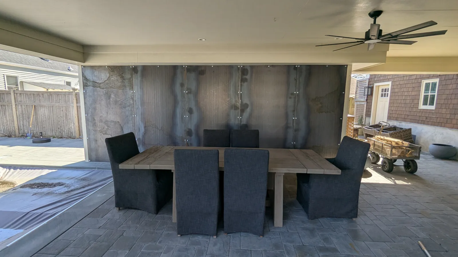 The finished panel wall at the back of a covered outdoor dining area in Mantoloking, NJ, with the table and chairs back in place