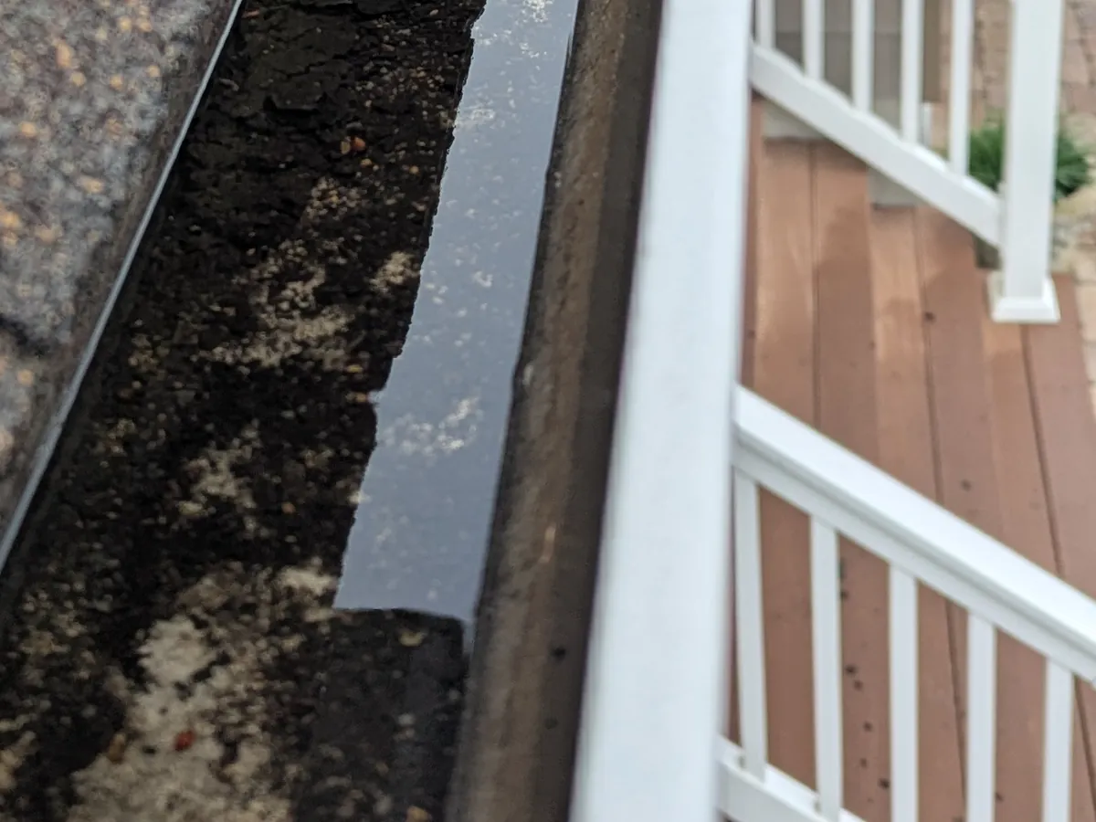 Before: Gutter cleaning in Point Pleasant, NJ, April 19, 2026. Leaves, roof grit, and black sludge out, water running clear.
